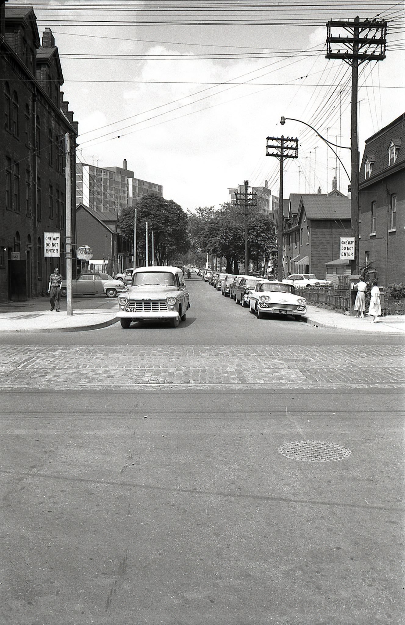 #17 Looking north along Sumach Street from Queen, 1960s. In the distance, two of Peter Dickinson’s Maisonette Towers are visible.