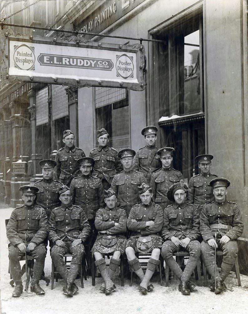 #43 Group of soldiers posing during a snow storm in front of the offices of E.L. Ruddy Company Limited, 1900s