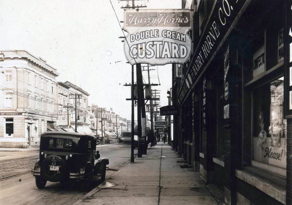 #57 Harry Horne’s Double Cream Custard – Queen Street West, at Cowan Avenue. View is looking east on Queen Street West, 1928