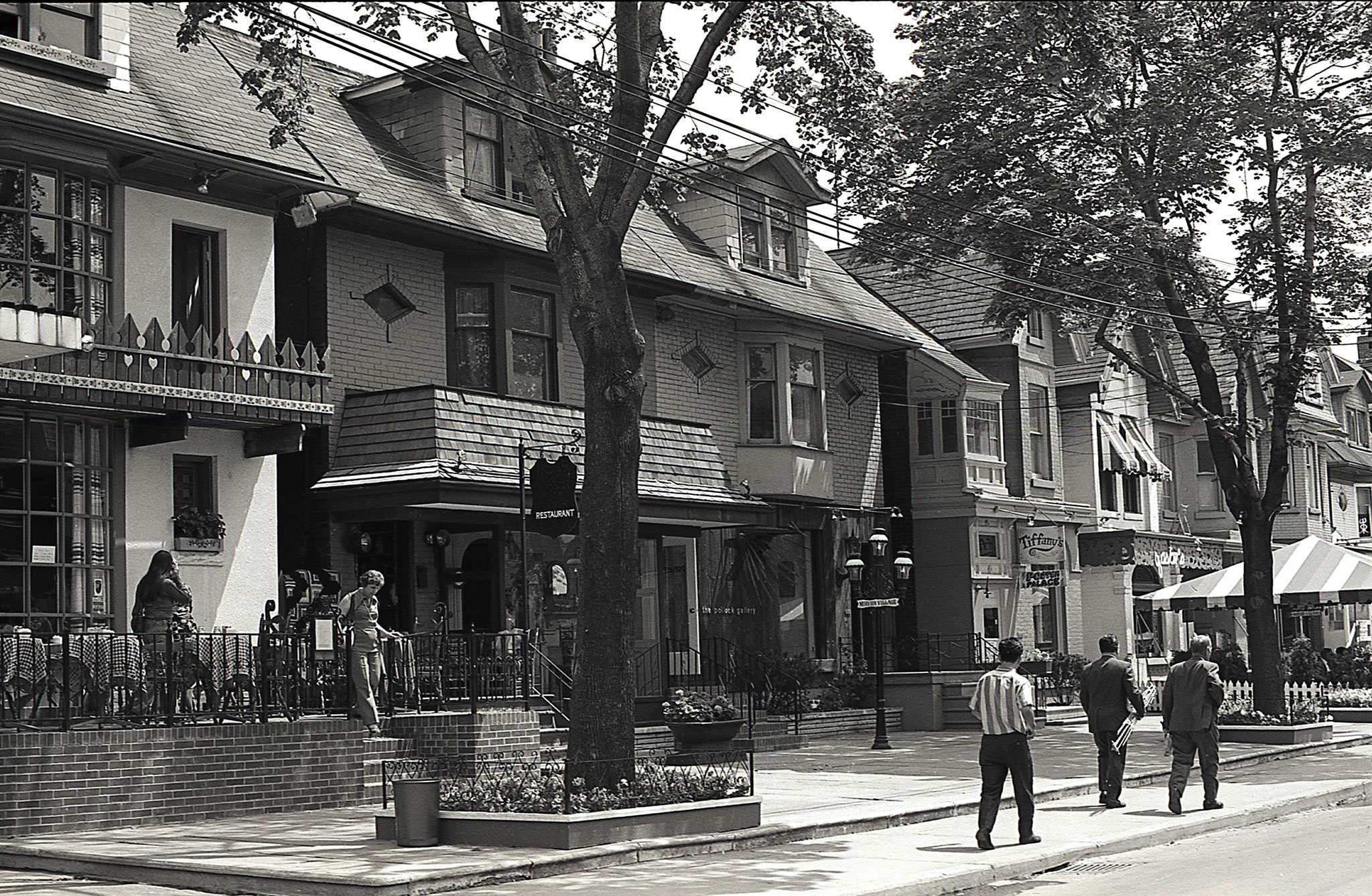 #76 Mirvish Village, around 1970. Looking south along the east side of Markham Street. Gaston’s French Restaurant, Tiffany’s, Poster Palace, and the Pollock Gallery.