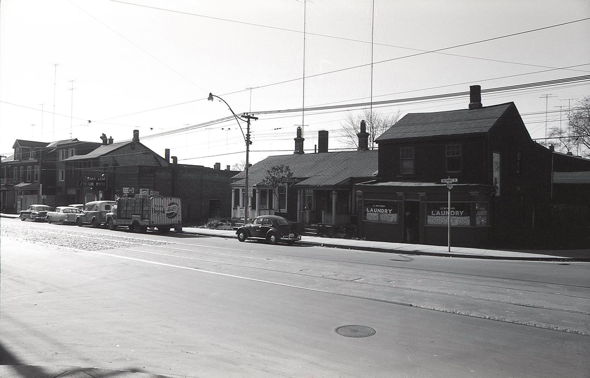 #70 Another view of the Oak Leaf Steam Baths, looking southwest from Bathurst and Robinson. The old Pepsi truck is a neat detail.” 216 Bathurst Street, late 1950s.