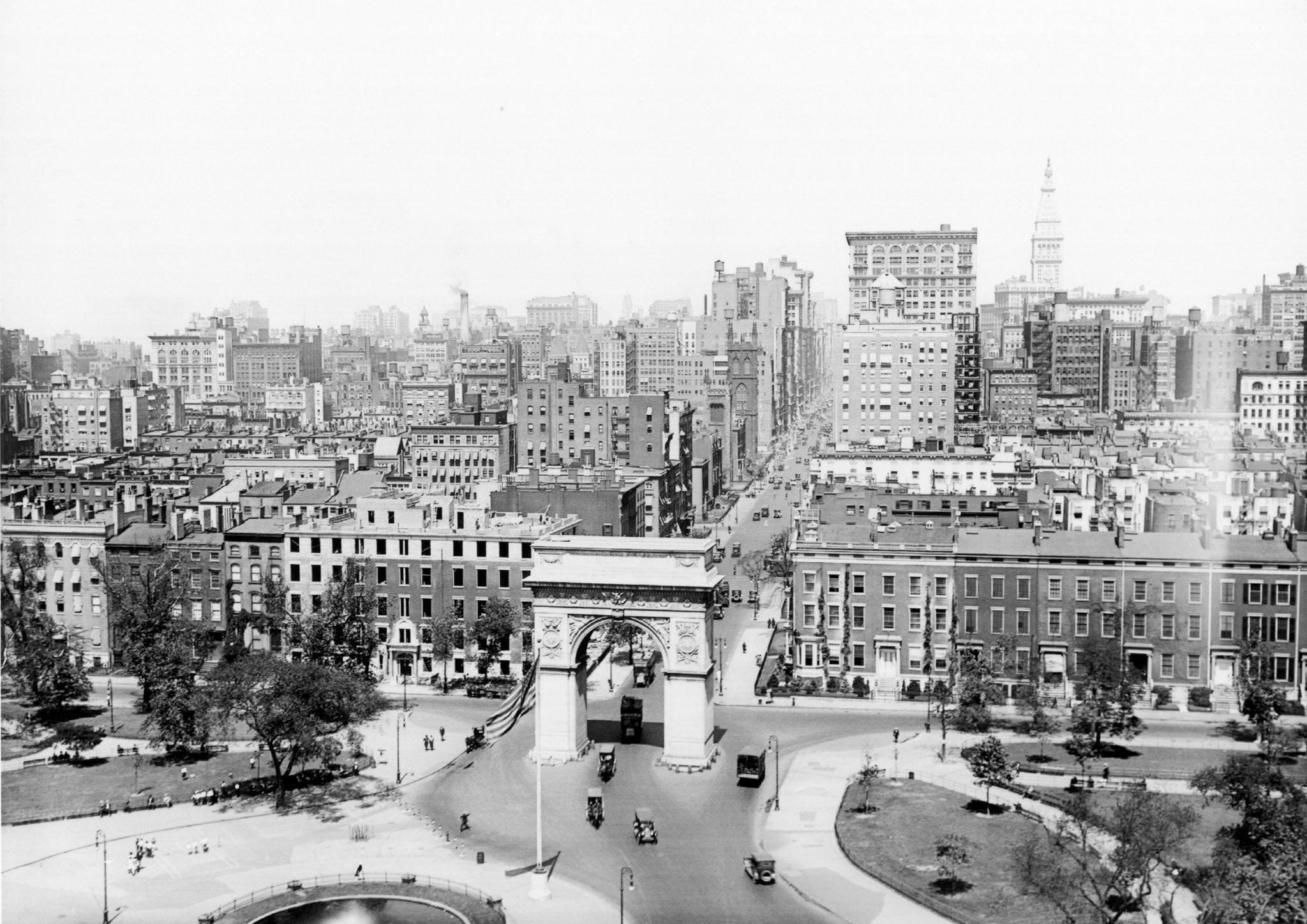 #41 View, looking north, at Washington Square Park, with traffic visible as it enters through the arch off Fifth Avenue, 1920