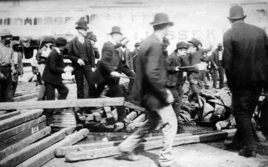 #7 Crowd of men with the steamer JESSE K. BELLE in background, 1880
