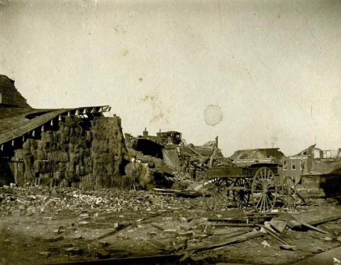 #16 The debris and structural damage of a barn, building, and wagon caused by a tornado on May 27,1896 in St. Louis, Missouri,