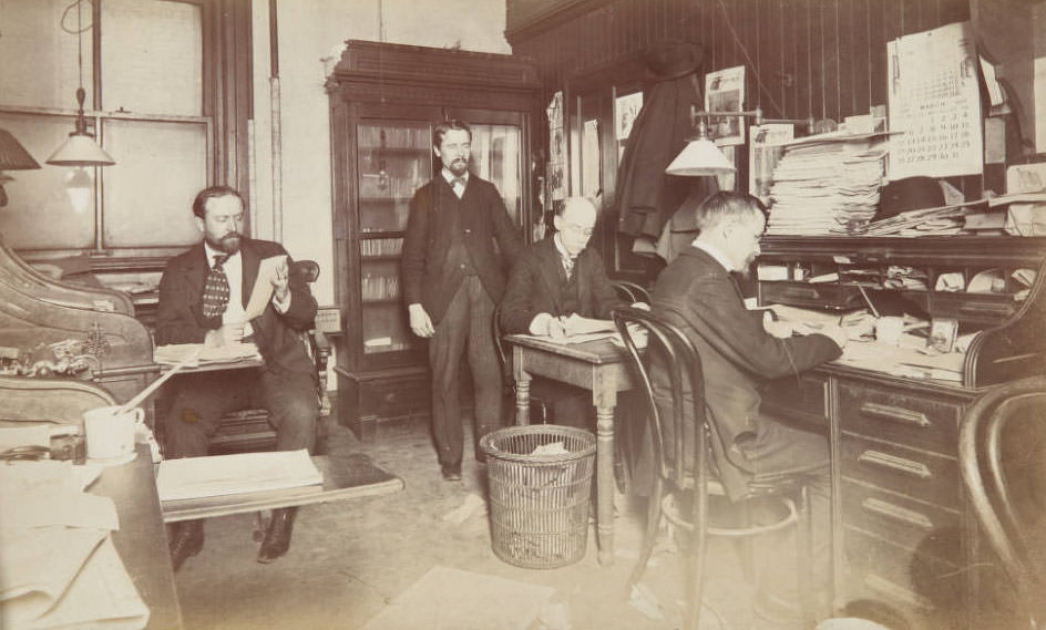 #57 Four Post-Dispatch men working in office, 1899