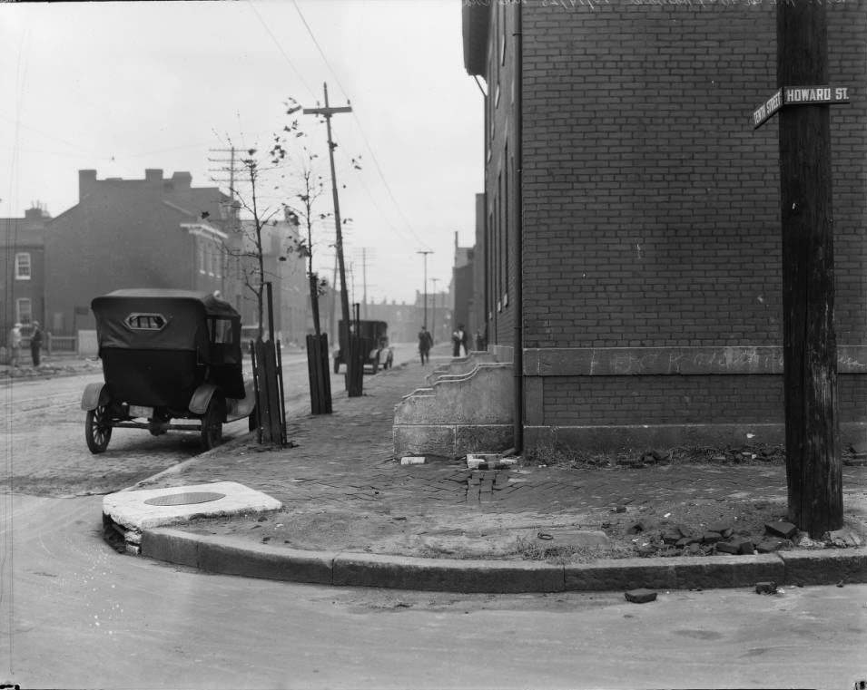#3 Brick rowhouses and sidewalk, includes two cars and pedestrians, 1925