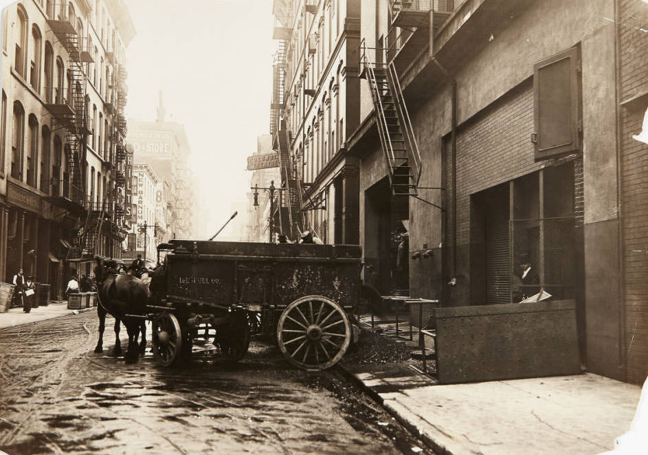 #44 A team of horses delivering a wagon full of coal for the Ice Fuel Co. to a business on St. Charles Street, 1910