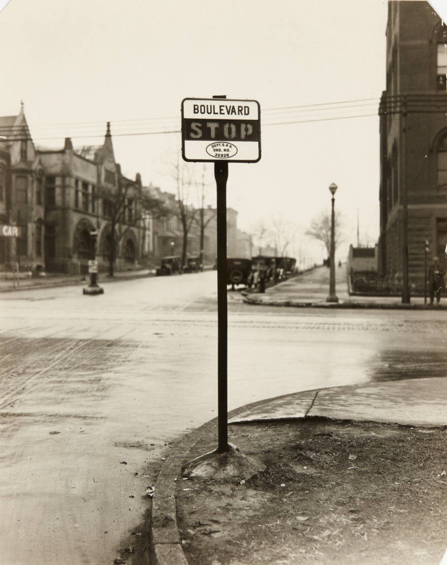 #65 A stop sign on the corner of West Pine Blvd. at its intersection with Grand, looking west, 1915