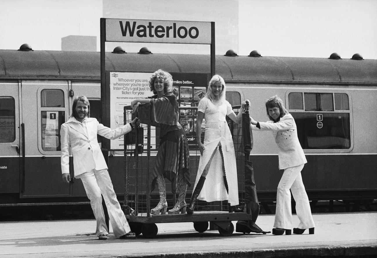 #35 Benny Andersson, Anni-Frid Lyngstad, Agnetha Faltskog and Bjorn Ulvaeus of the Swedish pop group ABBA posing at Waterloo railway station, 1974