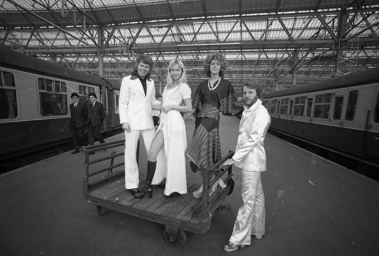 #36 Benny Andersson, Anni-Frid Lyngstad, Agnetha Faltskog and Bjorn Ulvaeus of the Swedish pop group ABBA posing at Waterloo railway station, 1974