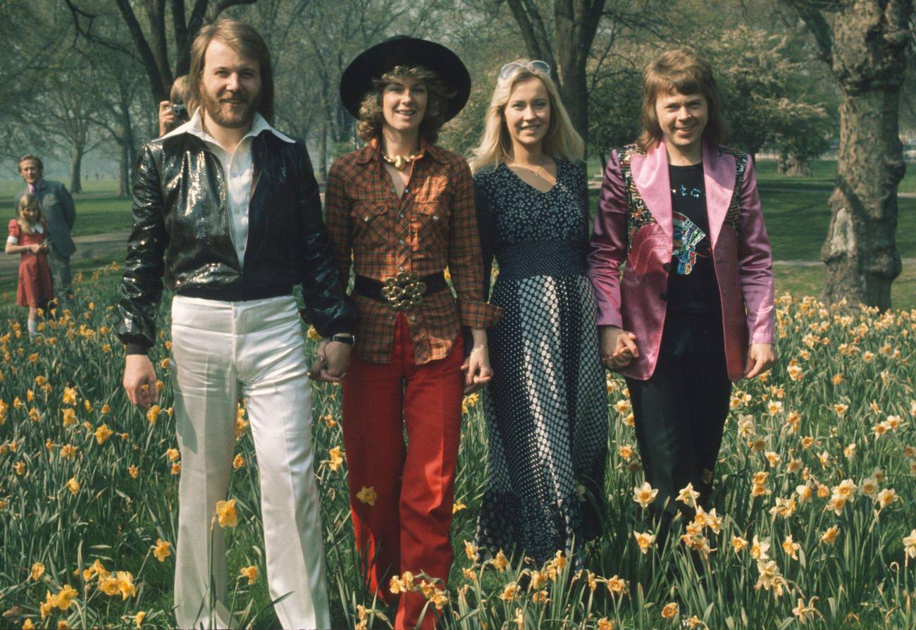 #38 Swedish pop group Abba at Brighton, strolling hand in hand amongst the daffodils in Hyde Park on April 09, 1974