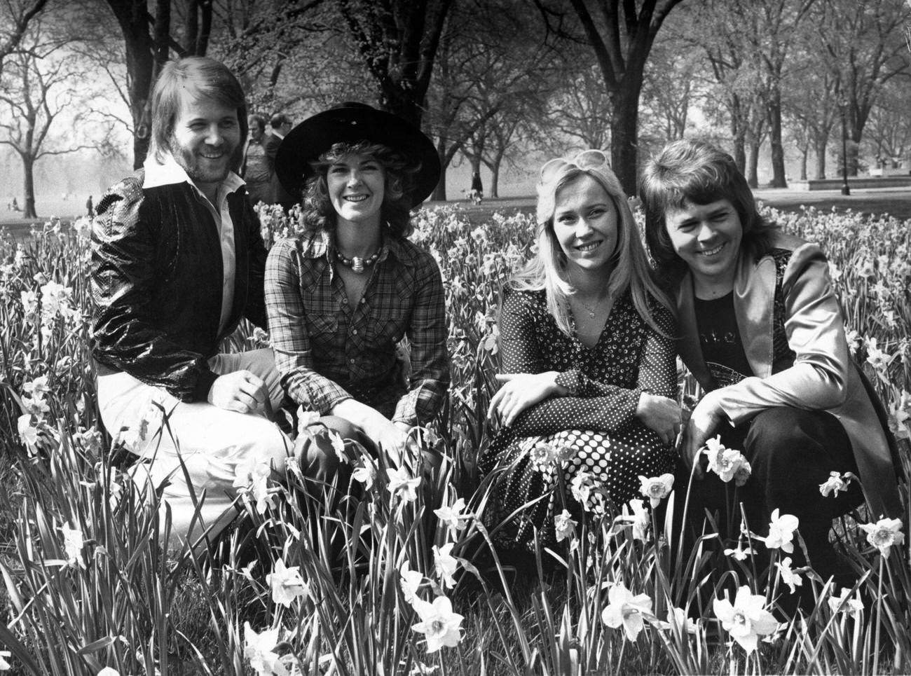 #39 Benny Andersson, Anni-Frid Lyngstad, Agnetha Faltskog and Bjorn Ulvaeus, sitting amongst the daffodils in London