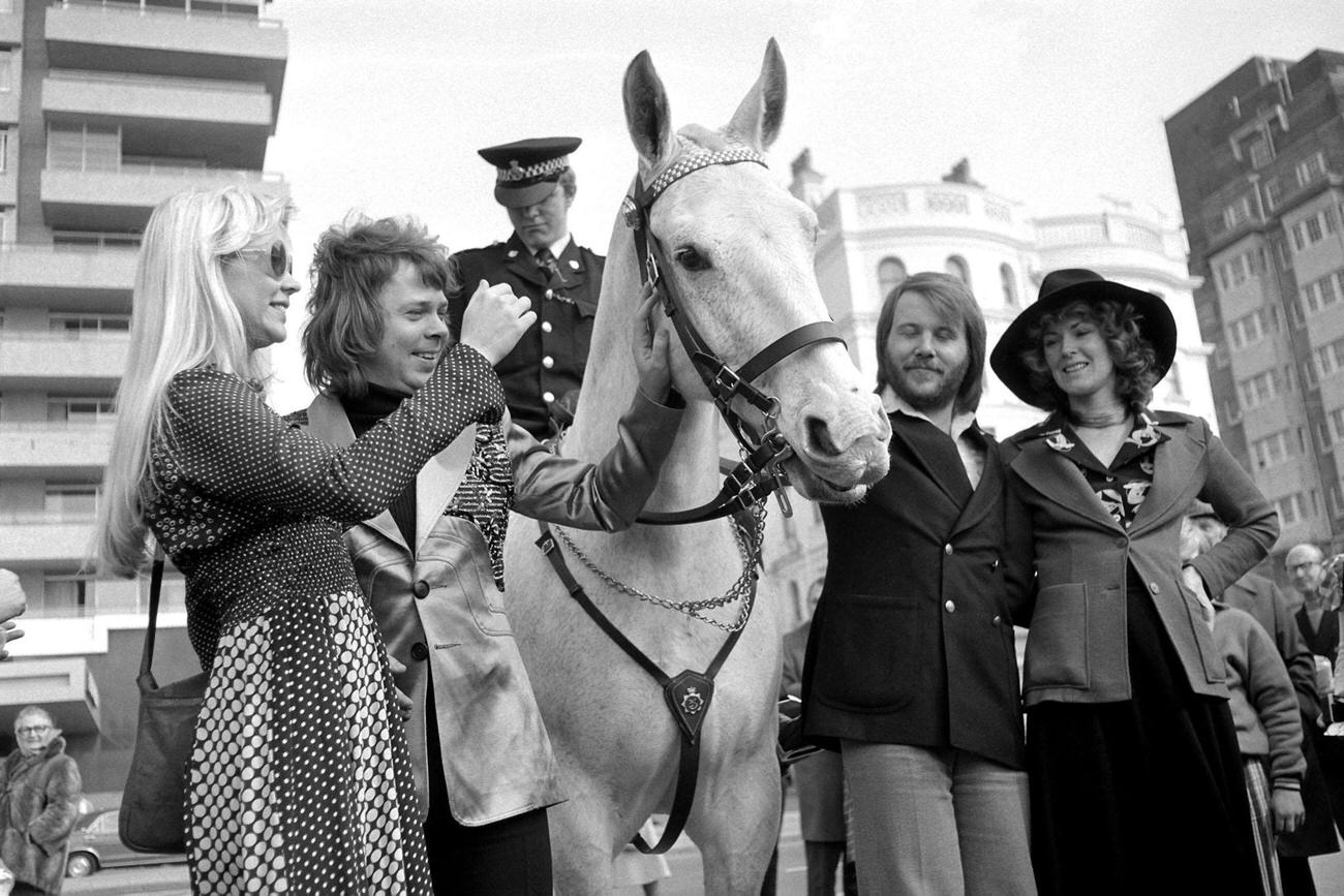 #43 Swedish pop group Abba meet a mounted policeman as they relax in Brighton, after their victory in the Eurovision Song Contest.