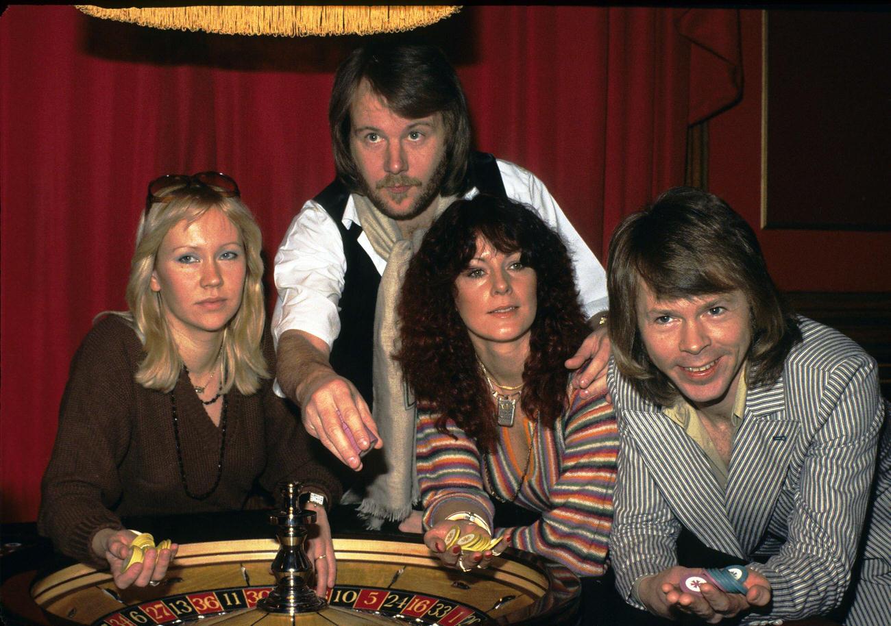 #62 Swedish pop group Abba (L-R) Agnetha Faltskog, Benny Andersson, Anni-Frid Lyngstad and Bjorn Ulvaeus, play roulette during a visit to London in 1974 in London, England.