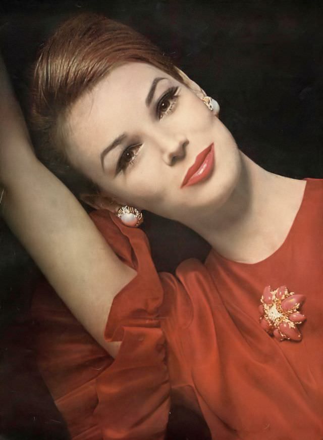 #14 Anne de Zogheb in ruffled cranberry blouse of doubled silk organza over a China silk lining by Sarff-Zumpano to order at Henri Bendel, Pure Cranberry lipstick by Coty, Vogue, July 1962