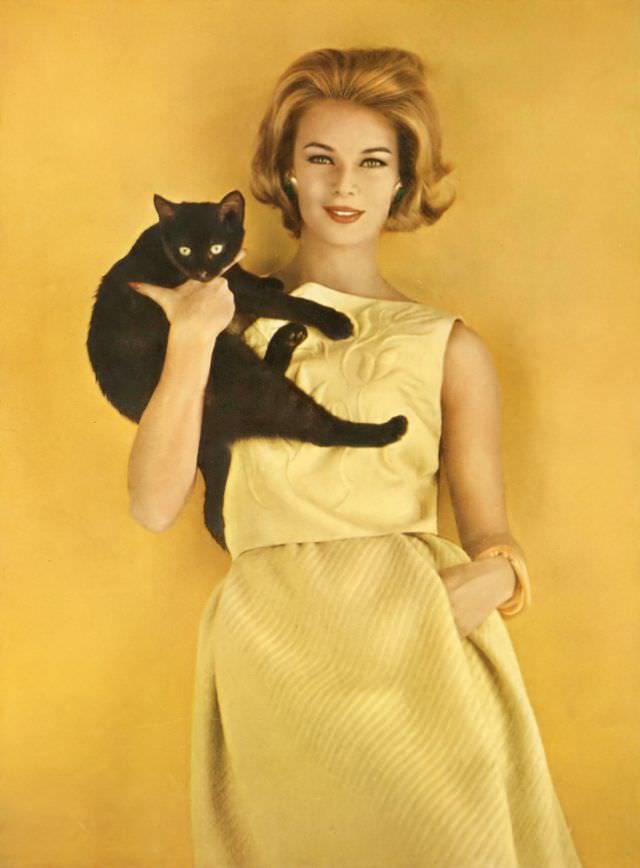 #19 Anne De Zogheb wearing a banana-yellow silk blouse sprayed with trapunto tulips and a matching wool tweed skirt both at Lord & Taylor as seen in Vogue, January 1962