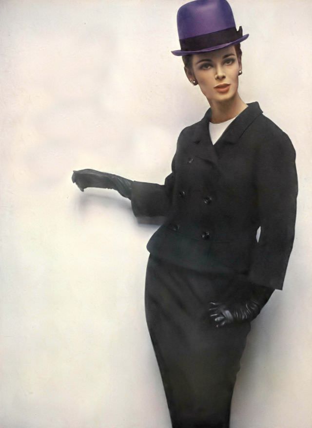 #23 Anne de Zogheb in black lightweight tweed suit, jacket flipped out at the hips over white silk blouse by George Carmel, violet straw bowler by Gustave Tassell, Vogue, January 15, 1963
