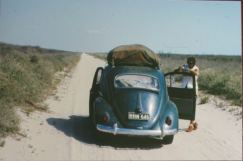 #53 VW rear with Betty somewhere remote, 1963