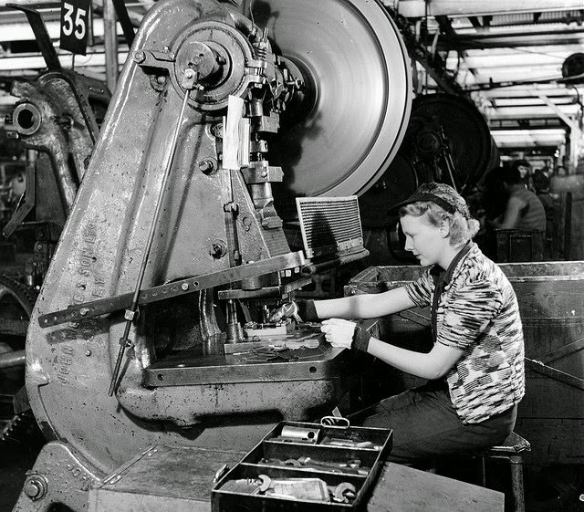 #1 A woman working at a machine making parts for ribs of Beaufort bombers in a munitions factory in South Australia.