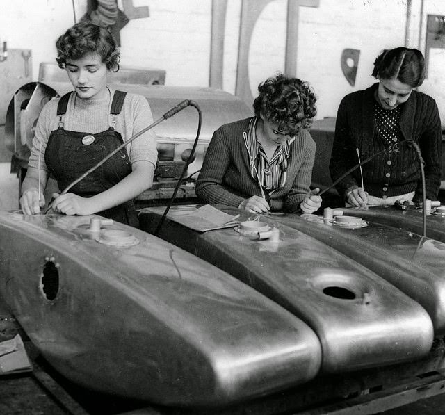 #14 Three young women cleaning dust from the interiors of Beaufort bomber oil tanks.