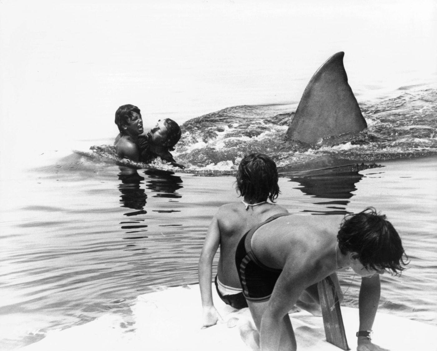 Boys attempt to escape the shark in a scene from the film ‘Jaws’, 1975.