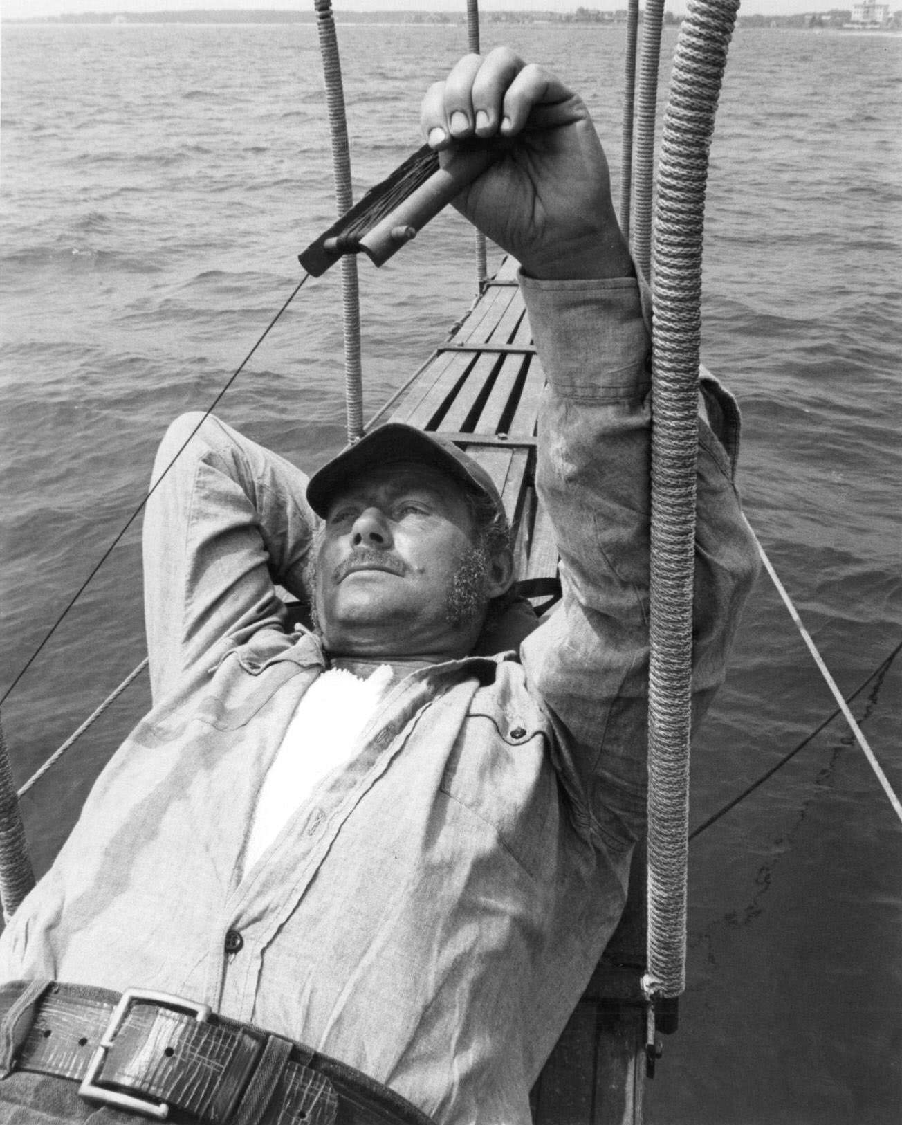 Robert Shaw lying down in boat in a scene from the film ‘Jaws’, 1975.