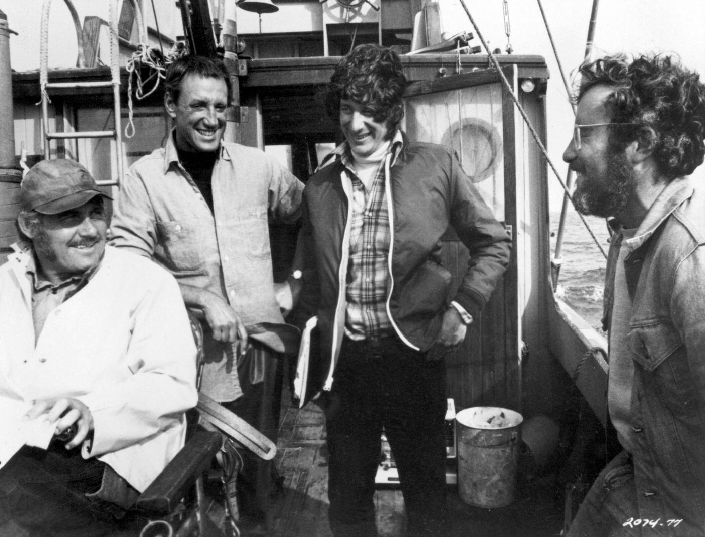 British actor Robert Shaw, American actor Roy Scheider, American director Steven Spielberg, and American actor Richard Dreyfuss laugh together on a boat during the filming of Spielberg’s ‘Jaws’, 1975