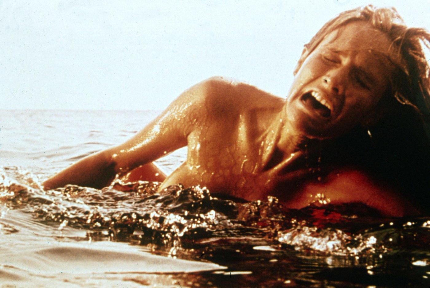 A female swimmer screams as she is attacked by a giant Great White shark (not pictured) in a still from the film ‘Jaws,’ 1975
