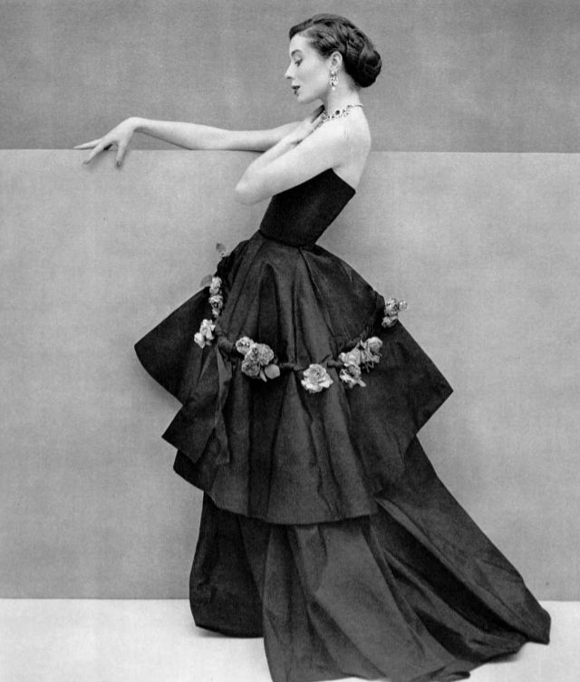 #73 Bettina in graceful black silk evening gown, the tunic is decorated with band of roses, by Grès, 1950