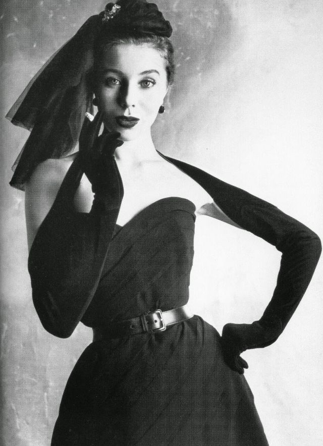 #77 Bettina in strapless belted dress of tucked silk crepe by Dior with bretelle gloves buttoning at the back, 1950