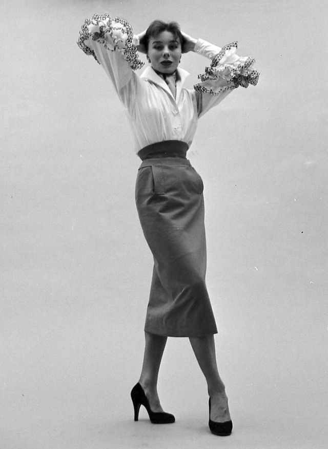 #92 Bettina in Givenchy’s cotton blouse with black embroidered ruffles called “Blanchisseuse” (washerwoman) tucked into a slim gabardine skirt, February 1952