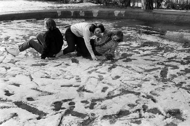 #20 Young people having fun with their fall on the frozen lake.
