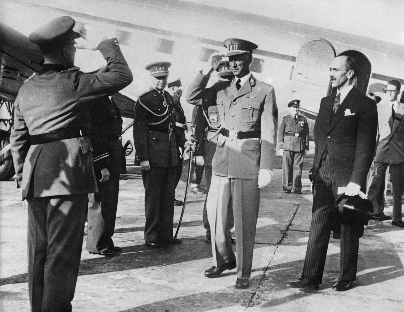 #9 King Leopold III of Belgium is greeted on his arrival as he returns to Brussels from exile in Swizerland where he has spent the last six years, 22nd July 1950.