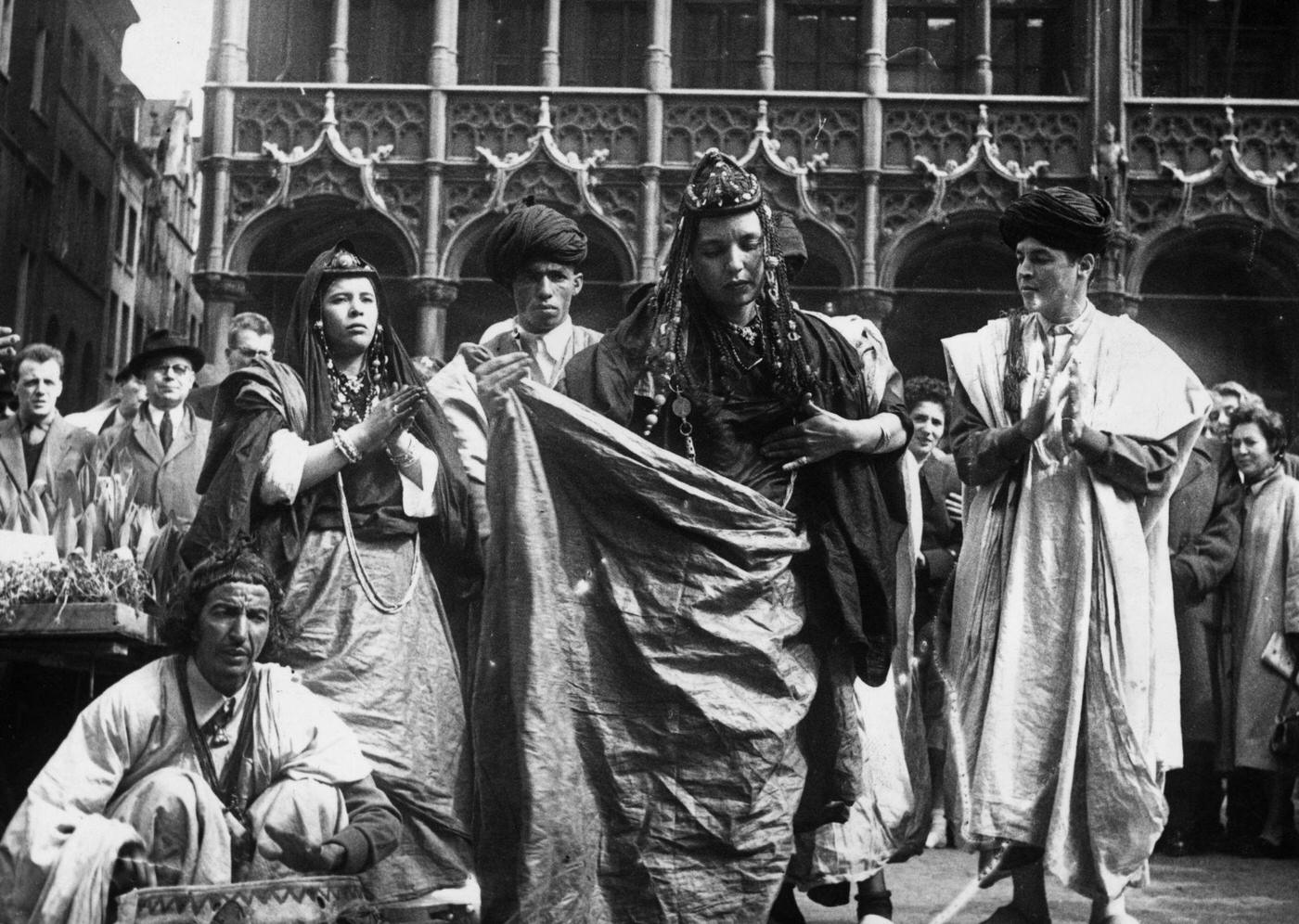 #15 A group of dancers of the Hommes Bleus (Blue People) tribe of Morocco performing a national dance in traditional garb in the Grand Place at Brussels, 1950