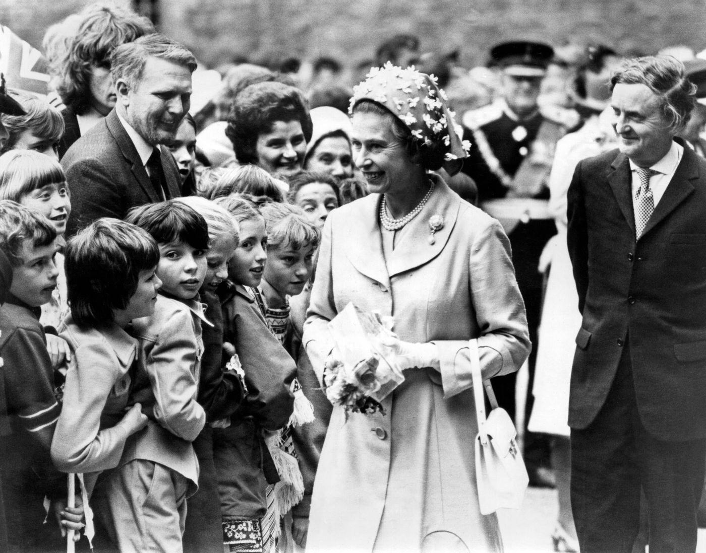 #16 Queen Elizabeth II visiting Wales during the silver jubilee tour. Pictured chatting to youngsters at Caerphilly castle, 24th June 1977.