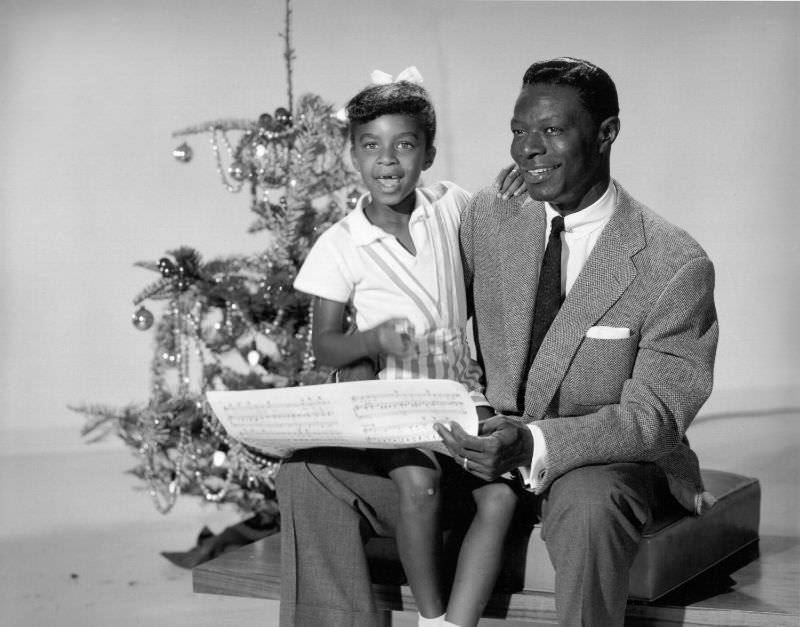#93 Nat King Cole sings carols with daughter Natalie Cole, 1970.