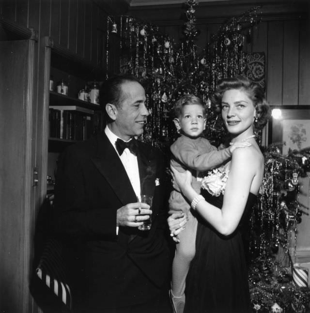 #36 Lauren Bacall and Humphrey Bogart celebrate Christmas Eve with their son, Stephen Bogart, in their home in California, 1951.