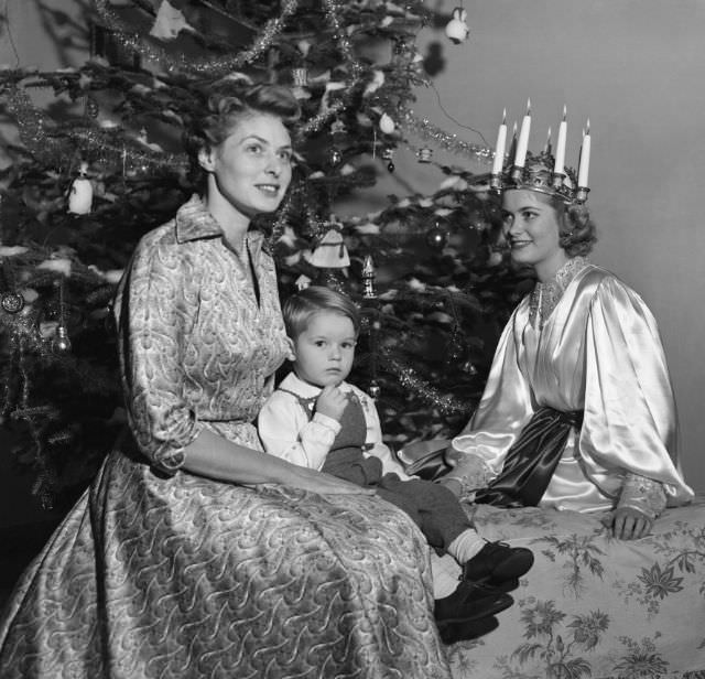 #86 Ingrid Bergman celebrates Swedish traditions with her two-year-old son, Renato Roberto Rossellini, 1952.