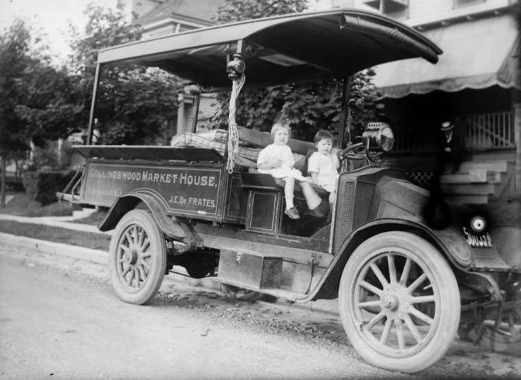 Collingswood Market House Truck owned by J.E. De Frantes. It’s hauling mattresses with 2 young children sitting in the truck, 1915