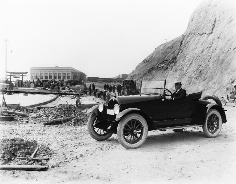 A 1922 “Dealer” license plate car at the historic San Francisco Cliff House with extensive construction taking place along the roadway and sidewalk, 1922