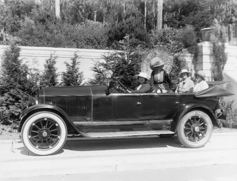 A carload of well-dressed ladies pictured in a Cole Motor Car convertible in San Francisco’s prestigious St. Francis Woods neighborhood, San Francisco, California, 1920s