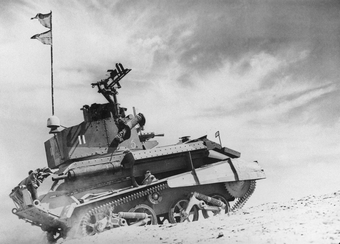 #23 A Vickers Light Tank MkVIb from the 8th (King’s Royal Irish) Hussars of the 7th Armored Division, British Army Western Desert Force on patrol in the Egyptian desert near Helmieh on 5th June 1940.