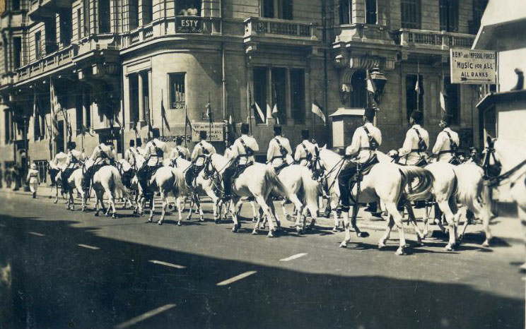 #61 Mounted Egyptian Police passing a sign saying “H.B.M.’s and Imperial Forces. Music for all ranks”
