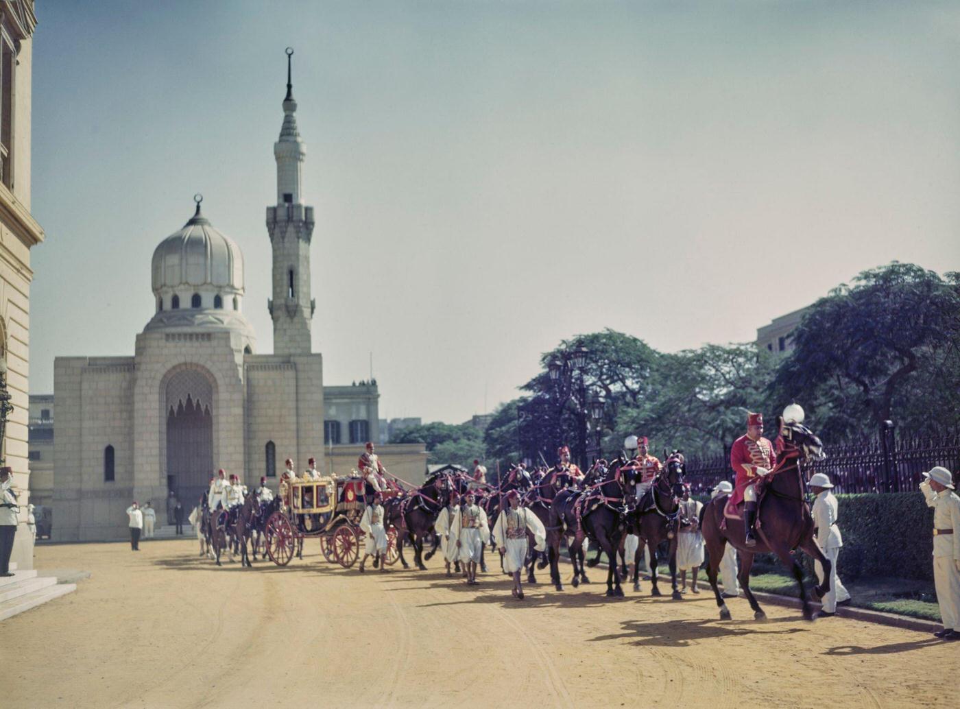 #11 King Farouk of Egypt (1920-1965) is transported by horse drawn carriage in a royal procession arriving for the state opening of Parliament in Cairo, Egypt in 1945