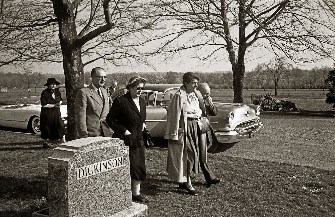 #4 On April 18, 1955, family and friends of Albert Einstein, including his son Hans Albert, his longtime secretary Helen Dukas, and his friend Dr. Gustav Bucky, gather at the Ewing Crematorium in Trenton, New Jersey, for his funeral service. An unidentified woman also joins them.
