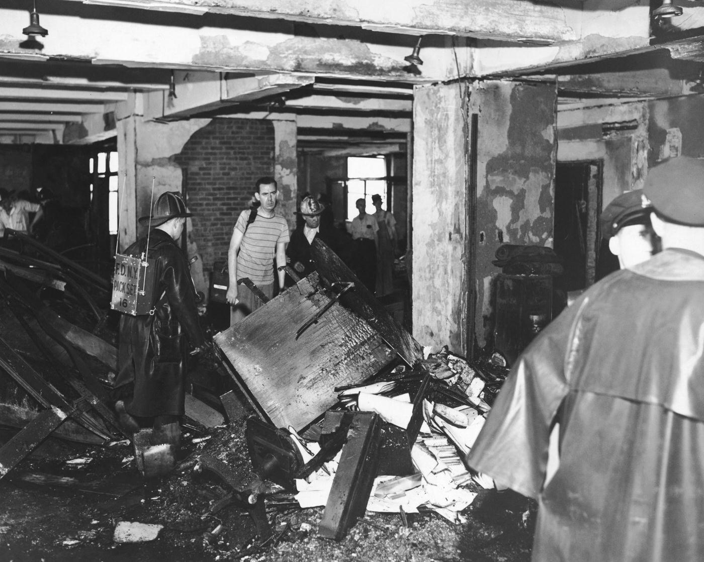 #11 Police and firemen examine a burned out office on the 79th floor of the Empire State Building, 1945