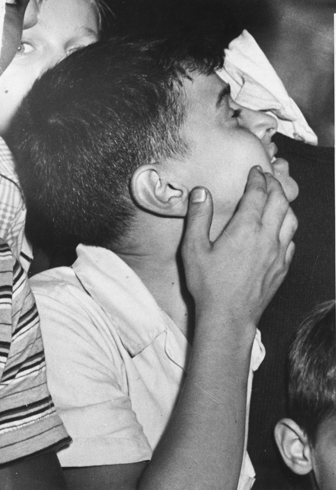 #20 A boy looking up at the Empire State Building where a plane (a North American Aviation B-25 Mitchell bomber) had crashed into the building