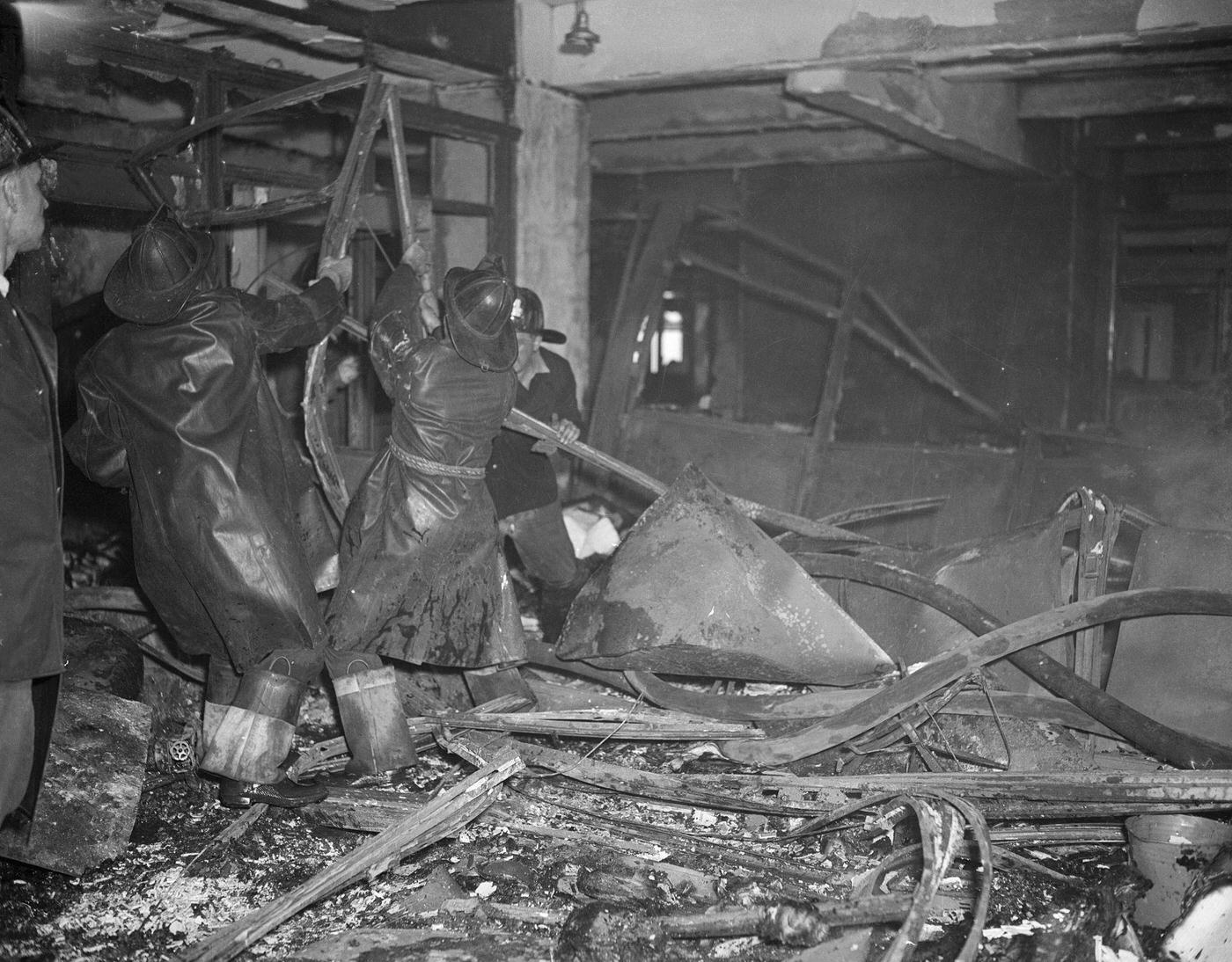 #28 Firemen working amidst the wreckage from a plane which crashed in to the Empire State Building.