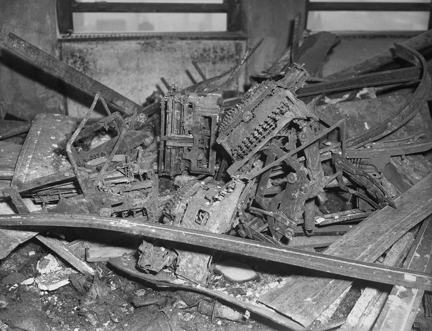 #33 Twisted metal is all that remains of typewriters at National Catholic Welfare Conference, on 79th floor of Empire State Building. Restoration work is proceeding at rapid pace on two hardest hit floors.