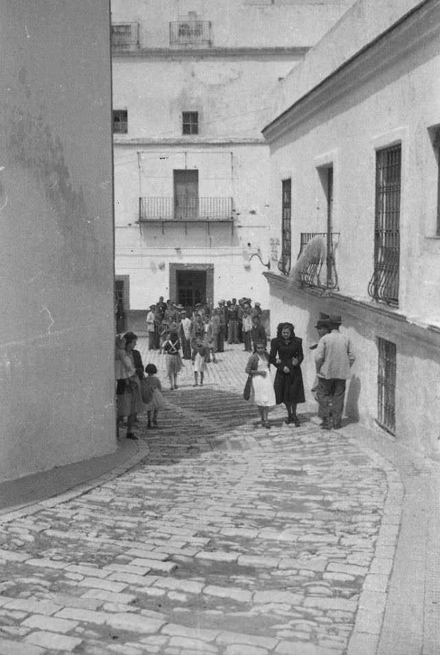 #140 Spain. Alley with woman and child, 1950